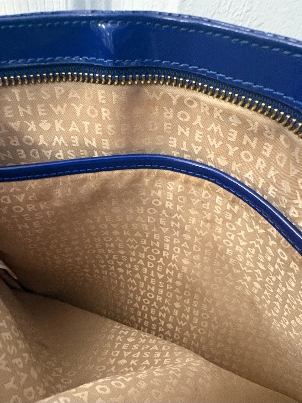 Kate Spade heart perforated patent leather crossbody in cobalt blue.
